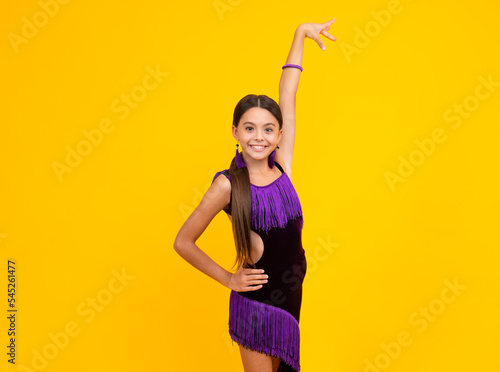 Ballroom teenager dancer isolated on studio yellow background. Latin classic dance. Rumba, samba dancing pose. Ballroom dance school for teenager kids girl. Dress movement.