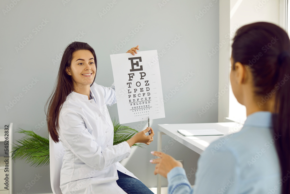 Optical eye test in oculist office. Ophthalmologist checks woman's