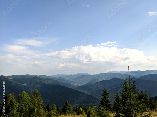Fototapeta Naklejka Na Ścianę i Meble -  Summer and autumn hiking in the Carpathian mountains, stunning views from the tops, blue cloudy sky, fog