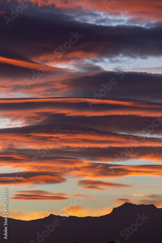 Spectacular lenticular clouds at dawn over the silhouette of the Sierra Nevada peaks (Granada, Spain) in autumn © Miguel Ángel RM
