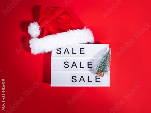 Christmas sale, boxing day lightbox on red with santa cap