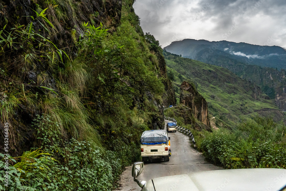 A steep mountain 4wd road along the side of the mountain, with guardrails at some section, Mananag Road, Nepal