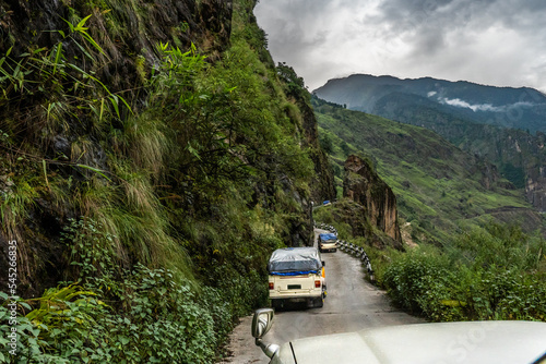 Canvas Print A steep mountain 4wd road along the side of the mountain, with guardrails at som