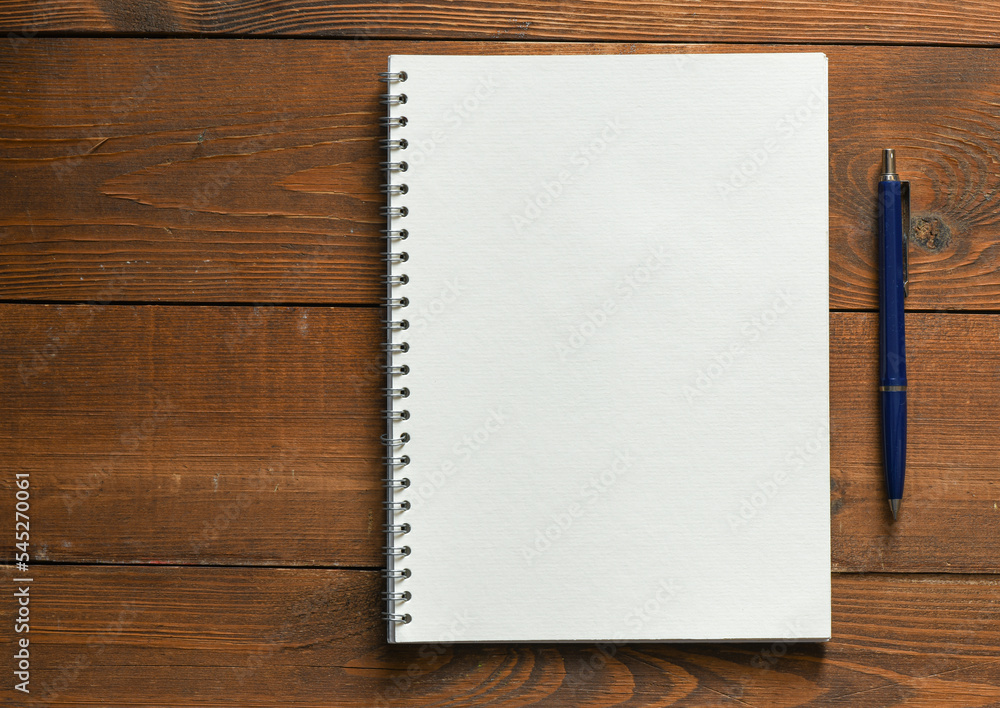 Blank notepad and on office wooden table Blank notepad and on office wooden table
