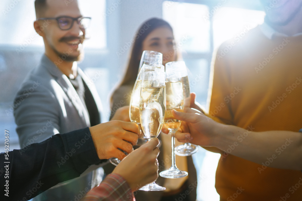 © maxbelchenko - Toasting to success concept.Group of young business people toasting each other and smiling while standing in the office. Celebration and festive concept. © maxbelchenko - Toasting to success concept.Group of young business people toasting each other and smiling while standing in the office. Celebration and festive concept.