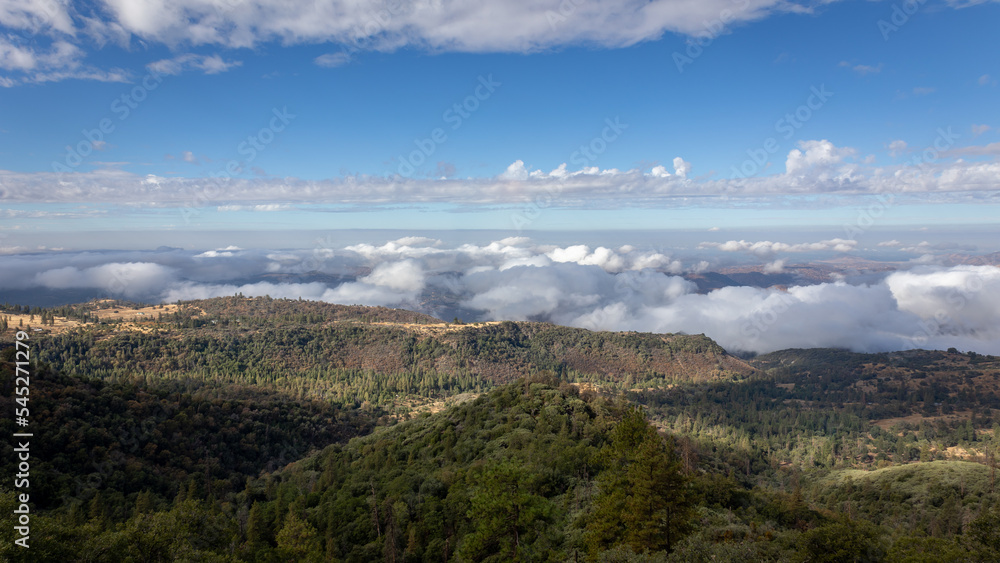 Beautiful vistas of the valleys and forests of Kings Canyon and Sequoia National Park, with low clouds and blue skies