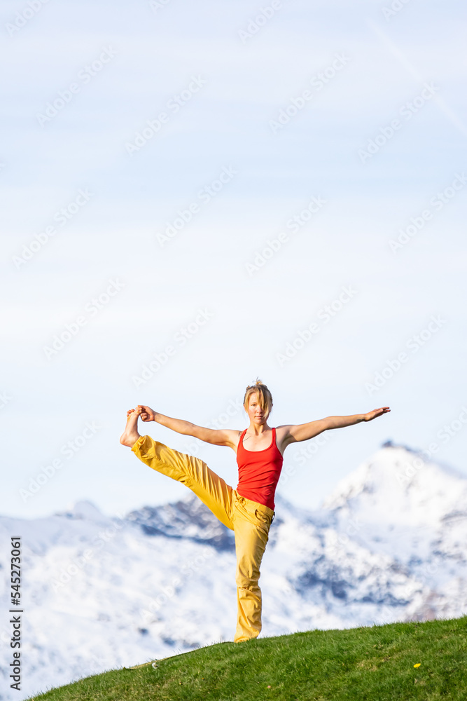 A girl doing yoga in the hight mountains