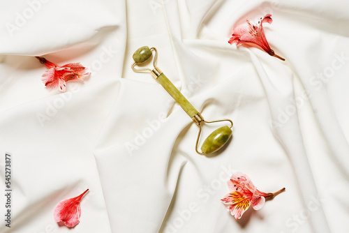 some flowers on a white sheet that has been made into a bed spread across the room with it's petals