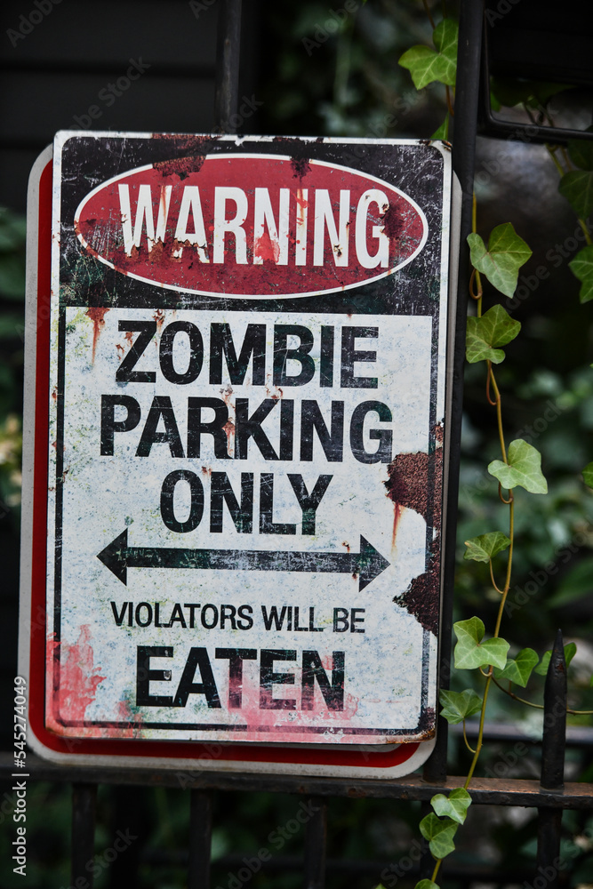 Warning zombie sign as outdoor Halloween decoration. Stock Photo