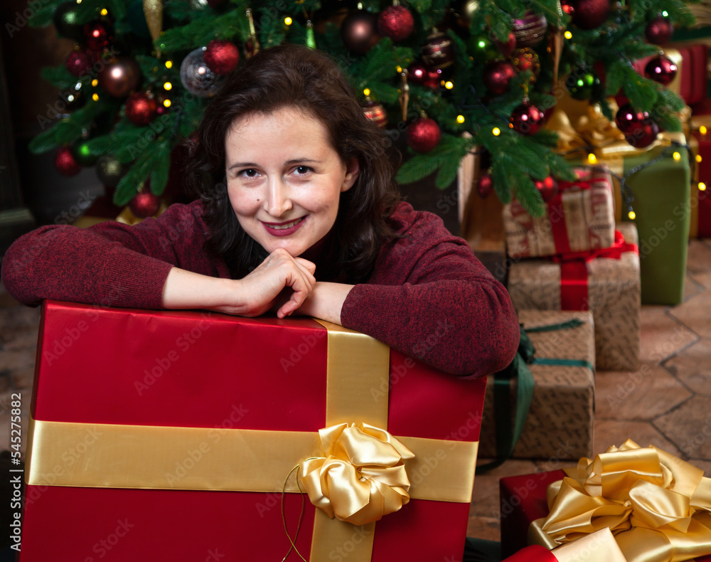 Naughty woman leans on a huge box with a New Year gift.... Naughty woman leans on a huge box with a New Year gift....