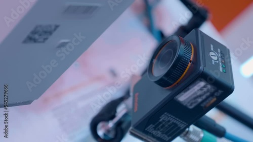 An industrial sensor-camera captures the passage of goods placed with a barcode and QR code and enters it into the database. Closeup