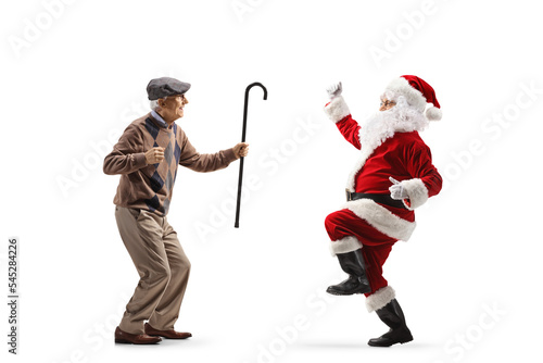 Full length profile shot of an elderly man dancing with santa claus