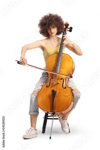 Young female artist sitting and playing a cello