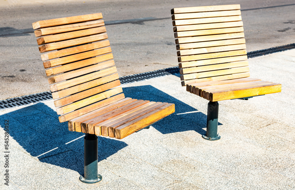 Outdoor wooden armchairs on the city street Outdoor wooden armchairs on the city street