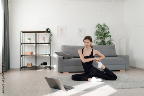 Woman with laptop exercising