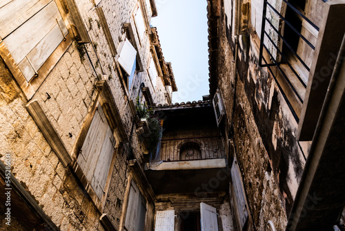 Streets with old buildings and the logo of Hajduk split football club in the old town of Trogir. Croatia. photo