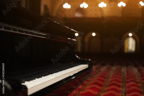 Photos piano on stage in an empty concert hall view from the stage