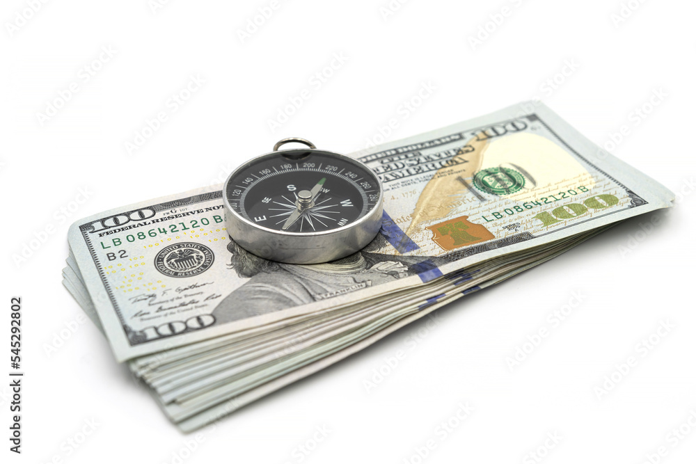 Pack of one hundred dollar bills and compass isolated on white background Pack of one hundred dollar bills and compass isolated on white background