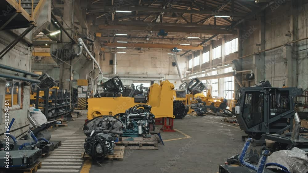 No people dolly shot of modern big tractor plant producing crawler tractors, bulldozers and other machines No people dolly shot of modern big tractor plant producing crawler tractors, bulldozers and other machines