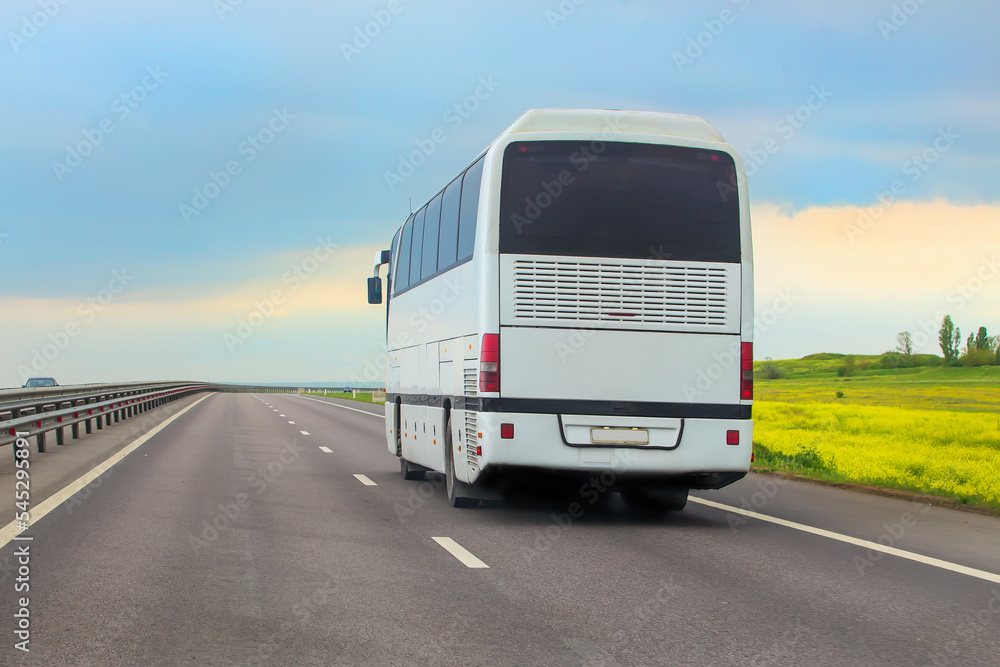 tourist bus moves along a suburban highway.