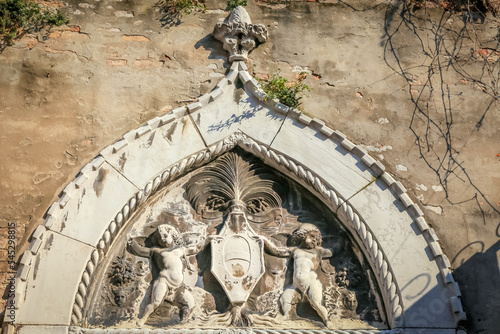 Coat of arms with pair of angels in old wall of Venice, Italy photo