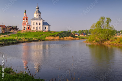 Orthodox church at golden sunrise with river, Suzdal, Russia