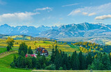 Summer mountain village outskirts and Tatra range behind (Gliczarow Dolny in valley, Poland)