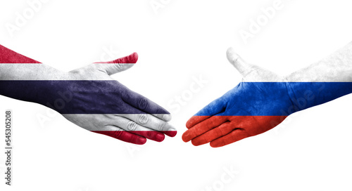 Handshake between Russia and Thailand flags painted on hands, isolated transparent image.