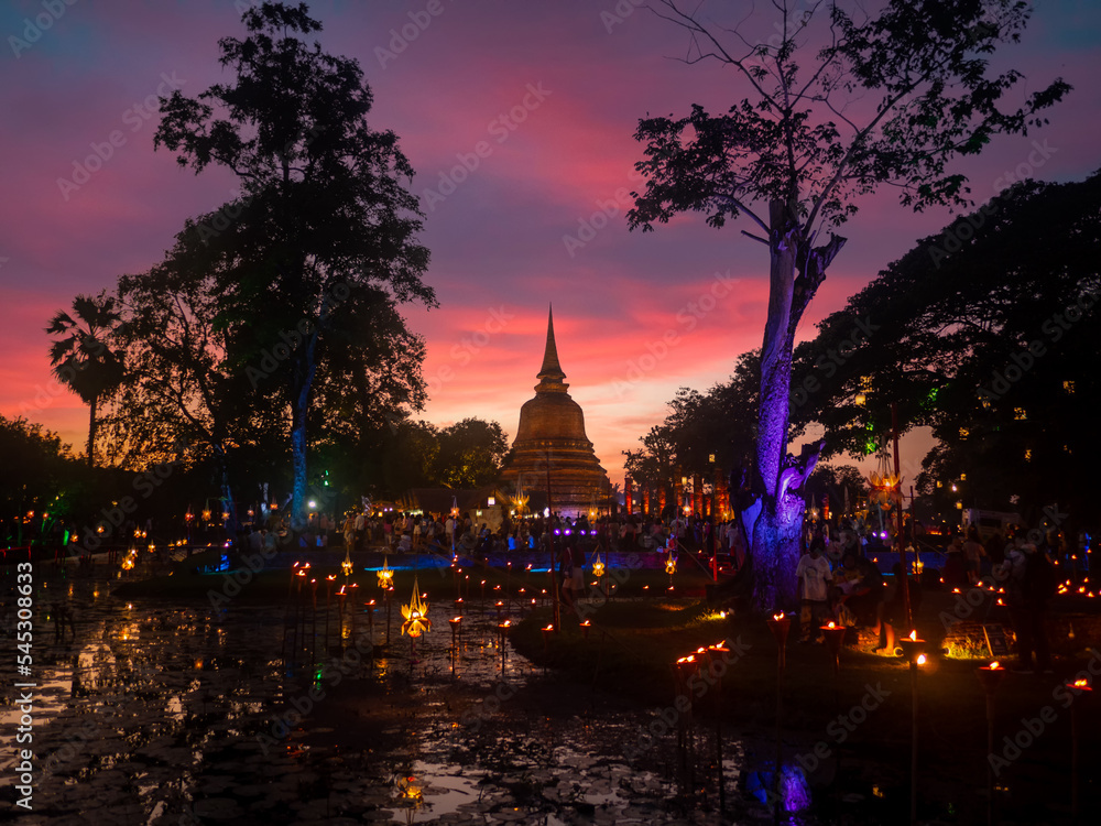 Beautiful scene of The light color Sukhothai Co Lamplighter Loy Kratong Festival at The Sukhothai Historical Park covers the ruins of Sukhothai Amazing Thailand.