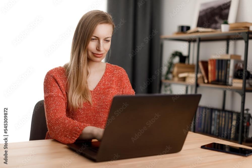 Woman using laptop at home Woman using laptop at home
