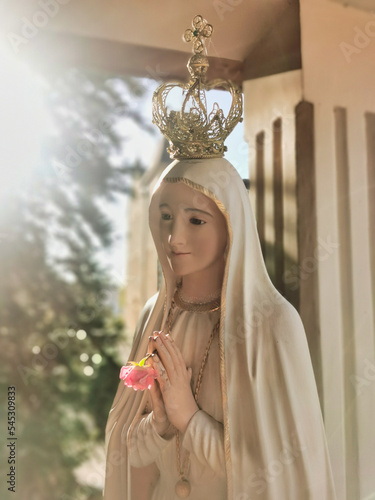 Mother Mary statue praying with her hands joined ,with a crown. Our Lady of Fatima. Paray-le-Monial, France.
