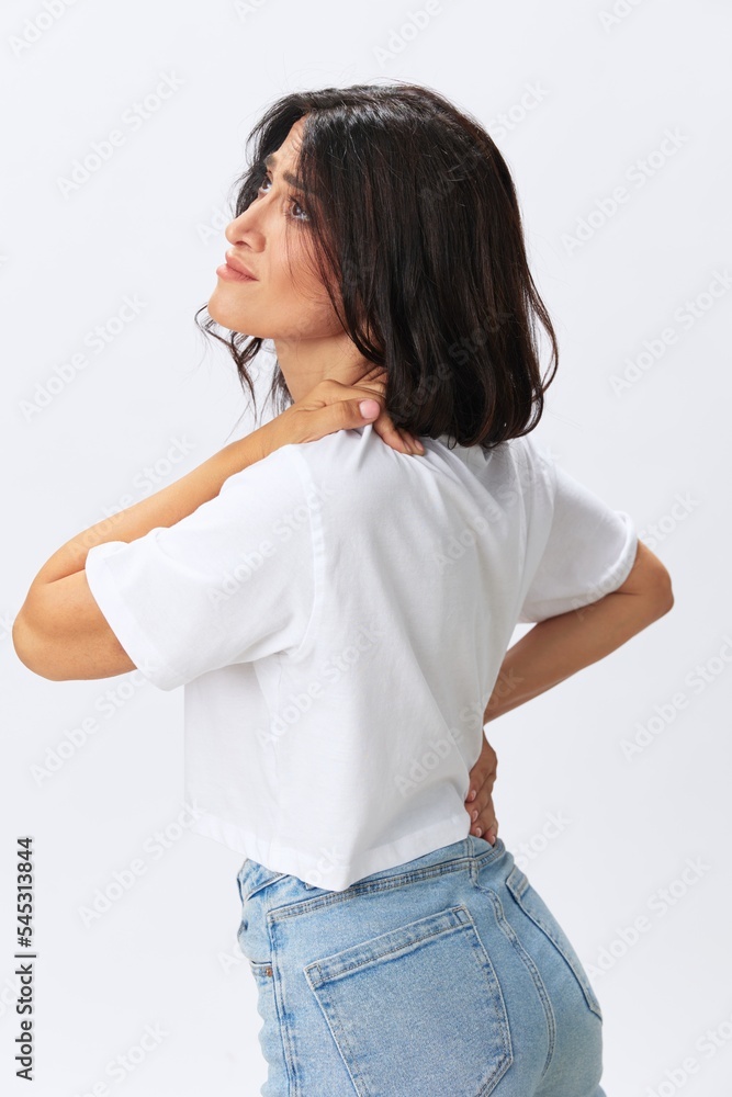 Woman sadness pain in the neck, back and head, spasms and diseases at a young age, white background, copy space Woman sadness pain in the neck, back and head, spasms and diseases at a young age, white background, copy space