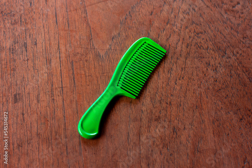 green comb hair on wooden floor