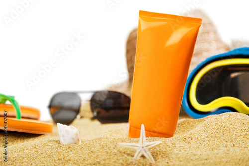 Mockup of sunglasses with tanning cream and mask on sand. travel concept photo