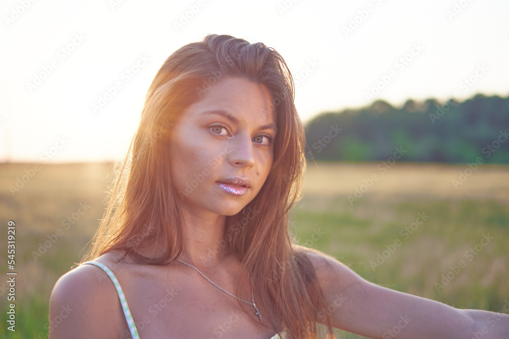 Portrait of a beautiful smiling young girl at sunset Portrait of a beautiful smiling young girl at sunset