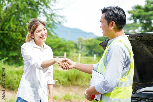 Closeup insurance company officers are congratulatory handshake with customer after completing the insurance claim.