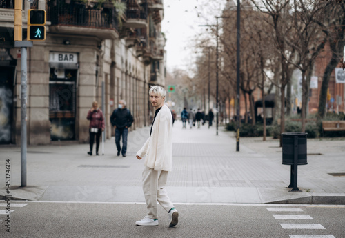 Blonde male with beard walking, crossing street. © Tetiana