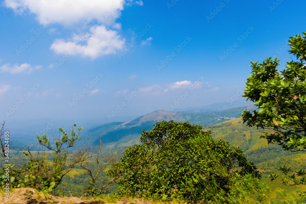 Beautiful hills of Chikmagalur,with fluffy clouds rolling over the blue sky. Beautiful hills of Chikmagalur,with fluffy clouds rolling over the blue sky.