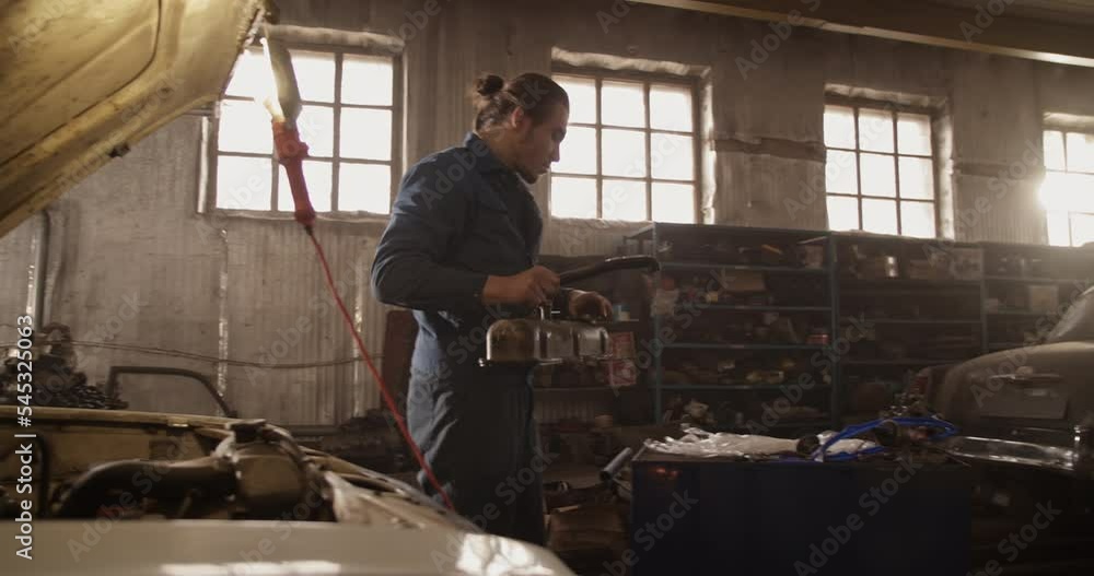 Mechanic removing cylinder head cover Mechanic removing cylinder head cover