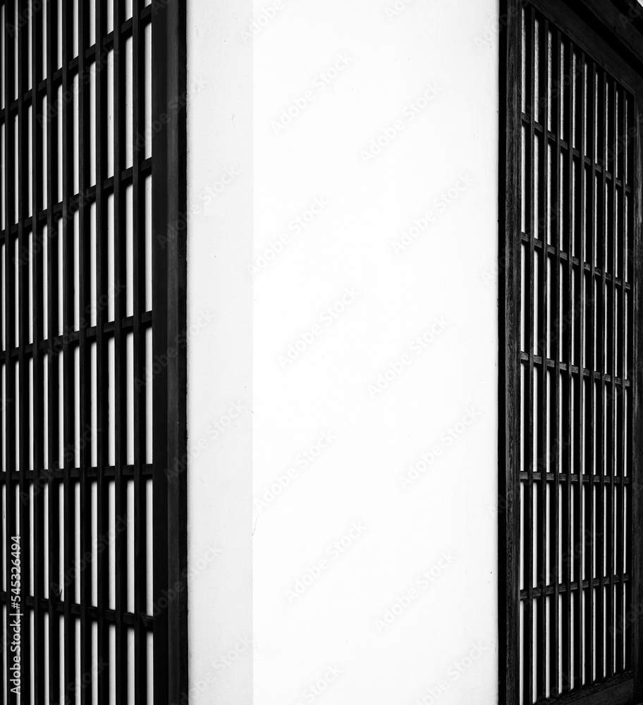 Abstract Corner Wall with White Concrete and Black Wooden Lattice. Abstract Corner Wall with White Concrete and Black Wooden Lattice.