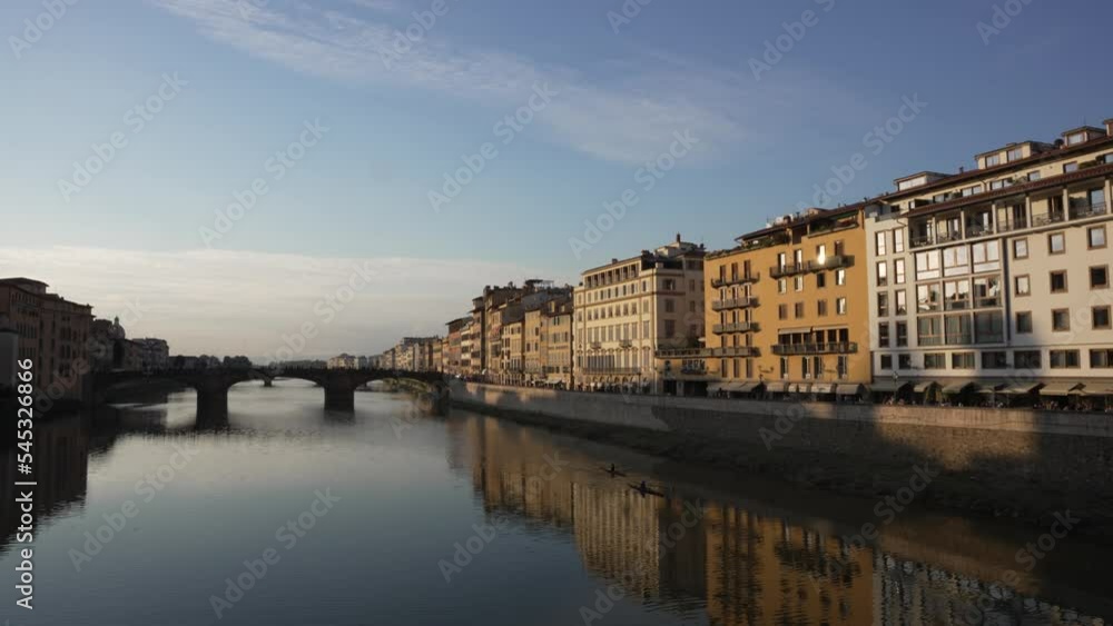 Early morning Florence river with people rowing down the, blue sky 4K Early morning Florence river with people rowing down the, blue sky 4K