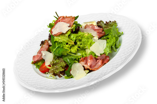 Close-up of tasty fresh salad in white plate isolated on white background