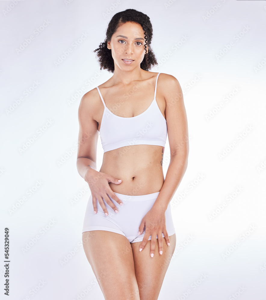 Fitness, wellness and portrait of black woman with slim body isolated on white background in studio. Beauty, exercise and female with healthy skin in underwear for diet, weight loss and body care Fitness, wellness and portrait of black woman with slim body isolated on white background in studio. Beauty, exercise and female with healthy skin in underwear for diet, weight loss and body care