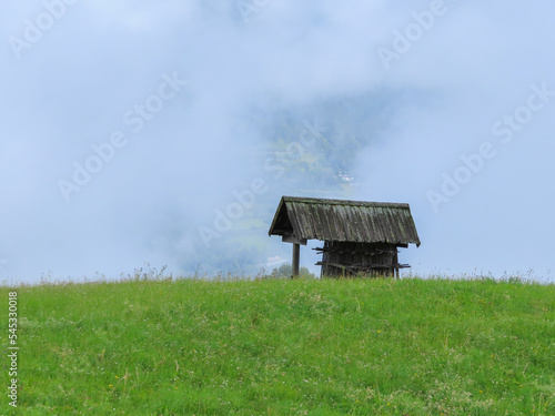 Eine einsame Hütte vor einer Wolke in den Bergen