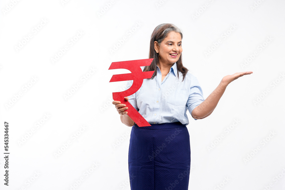 Indian senior lady holding rupees symbol in hand on white background. Indian senior lady holding rupees symbol in hand on white background.