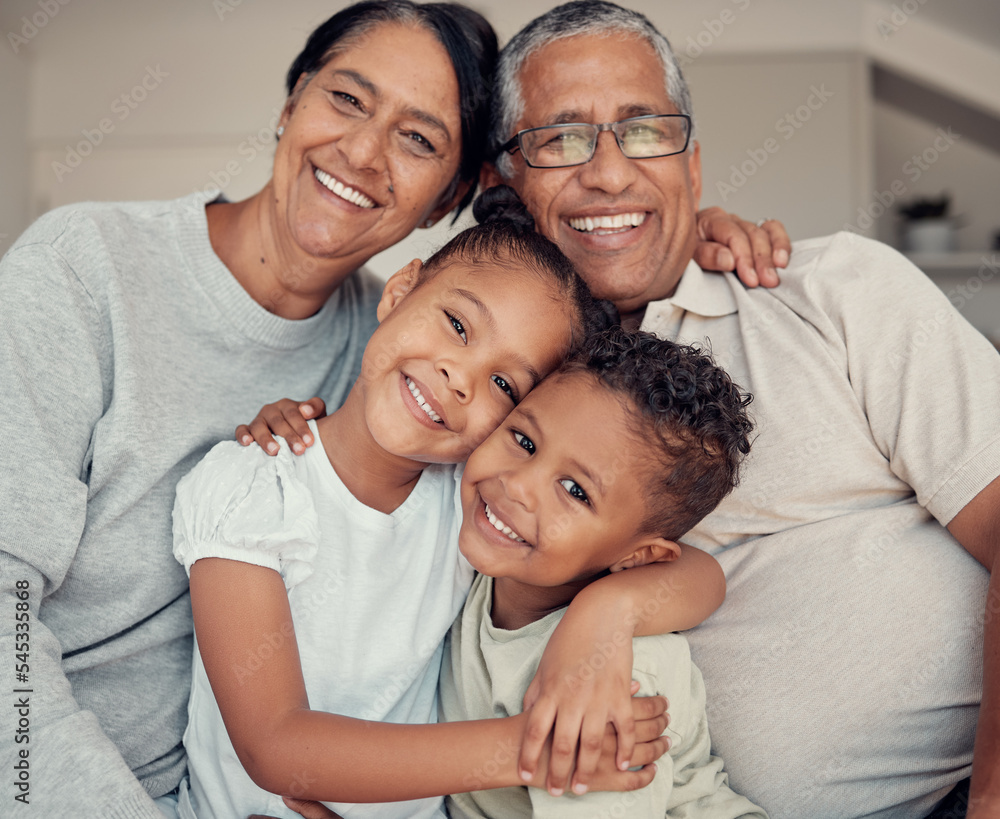 Family portrait, happiness and love of children and grandparents with a smile, hug and support while together on a living room couch at home. Face, care and happy kids with a senior man and woman