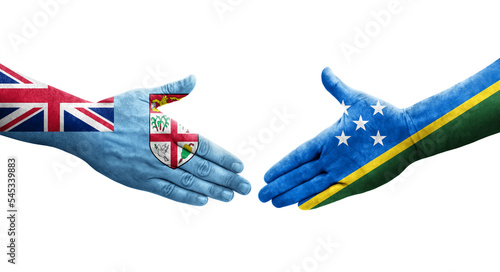 Handshake between Solomon Islands and Fiji flags painted on hands, isolated transparent image.