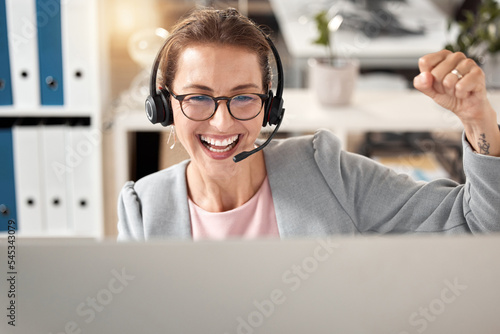 Woman at call center, celebrate and success at work with winner, successful customer service or sale for telemarketing. Happy about achievement, phone call with victory and contact us, job well done.
