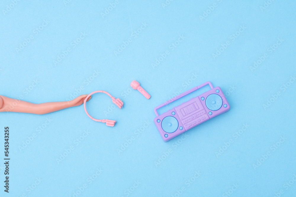 hand puppet with headphones, microphone and boombox tape recorder on a blue background. Karaoke, music concept hand puppet with headphones, microphone and boombox tape recorder on a blue background. Karaoke, music concept