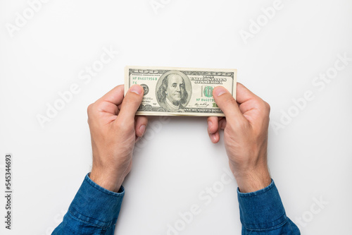 male hands hold a hundred dollar bill, top view, close-up